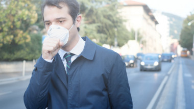 Man wearing mask against smog air pollution