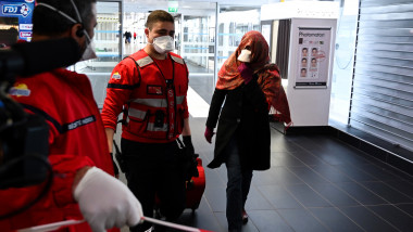 A woman wearing a protective facemask is evacuated from the security zone where a bus comming from Milan is blocked at the train and bus station Lyon Perrache, due to suspected COVID-19 the novel coronavirus on board, in Lyon, on February 24, 2020., Image: 500677182, License: Rights-managed, Restrictions: , Model Release: no, Credit line: JEAN-PHILIPPE KSIAZEK / AFP / Profimedia