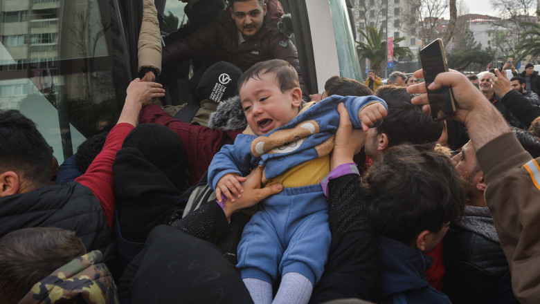 copil plânge în timp ce e urcat într-un autobuz unde sunt îngrămădiți refugiații sirieni la granița Turcia cu Grecia