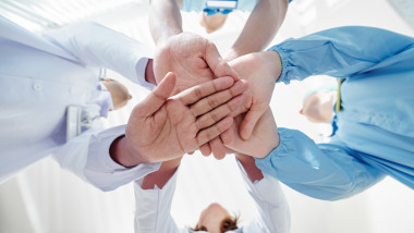 Medical team stacking hands