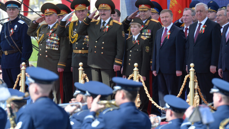 MINSK, RUSSIA - MAY 9: In this handout image supplied by Host photo agency / RIA Novosti, President of Belarus Alexander Lukashenko, center, watches the United States Air Force Band performing during the celebration of the 70th anniversary of Victory in the 1941-1945 Great Patriotic War in the Hero City of Minsk, May 9, 2015 in Minsk, Russia. The Victory Day parade commemorates the end of World War II in Europe. (Photo by Host photo agency / RIA Novosti via Getty Images)