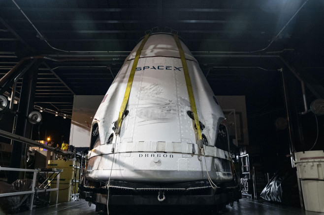 The SpaceX Crew Dragon spacecraft is offloaded from the company's recovery ship, Go Searcher, at Port Canaveral in Florida following the uncrewed In-Flight Abort Test, on January 19, 2020. SpaceX and NASA are targeting May 27 for Falcon 9's launch of Crew