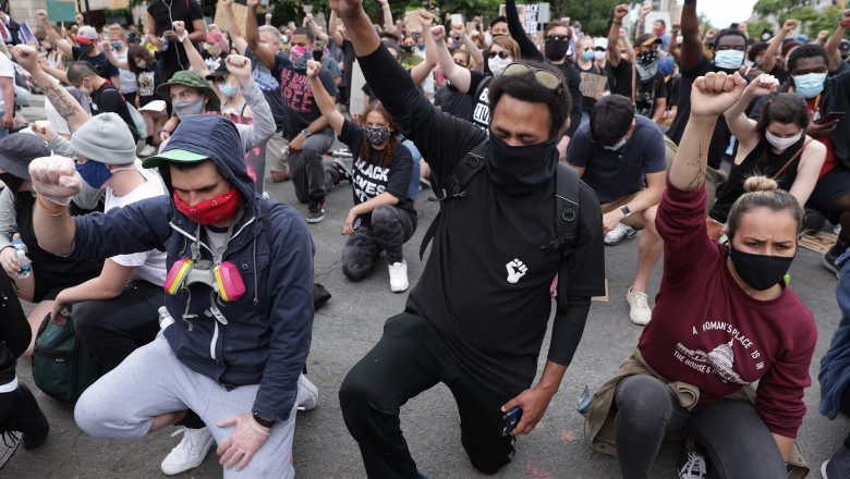 WASHINGTON, DC - JUNE 02: Demonstrators kneel and raise their fists during a protest against police brutality and the death of George Floyd, on June 2, 2020 in Washington, DC. Protests continue to be held in cities throughout the country over the death of George Floyd, a black man who was killed in police custody in Minneapolis on May 25. (Photo by Alex Wong/Getty Images)