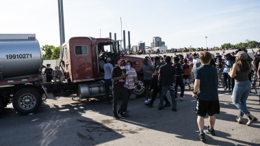 MINNEAPOLIS, MN - MAY 31: People react after a tanker truck drove into a crowd peacefully protesting the death of George Floyd on the I-35W bridge over the Mississippi River on May 31, 2020 in Minneapolis, Minnesota. A large group of protesters had been marching over the bridge on both lanes before the truck drove into the crowd. (Photo by Stephen Maturen/Getty Images)