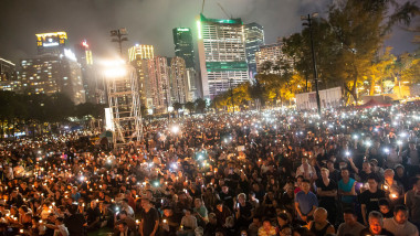 People hold candles during a candlelight vigil at Victoria Park in Hong Kong, to mark the 30th anniversary of the 1989 Tiananmen crackdown in Beijing. 30th anniversary of the Tiananmen Square massacre, Hong Kong, China - 04 Jun 2019,Image: 446901946, License: Rights-managed, Restrictions: , Model Release: no