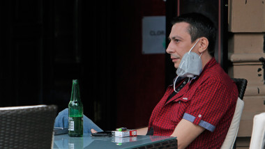 (200601) -- BUCHAREST, June 1, 2020 (Xinhua) -- A man enjoys a bottle of beer on the reopened terrace of a restaurant in Bucharest, Romania, on June 1, 2020. Romania adopted new relaxation measures from June 1, including reopening open-air terraces of restaurants and beaches, lifting the travel restrictions for residents, as well as allowing outdoor shows and sports events.,Image: 525387907, License: Rights-managed, Restrictions: , Model Release: no