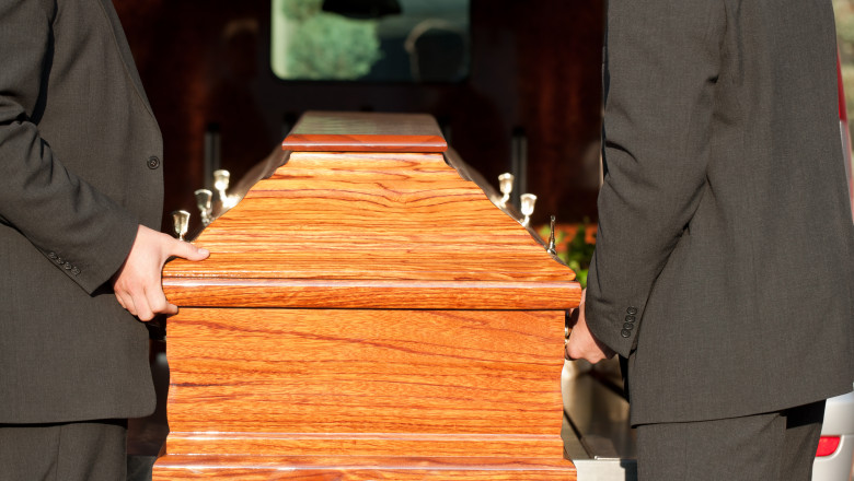 Funeral with casket carried by coffin bearer