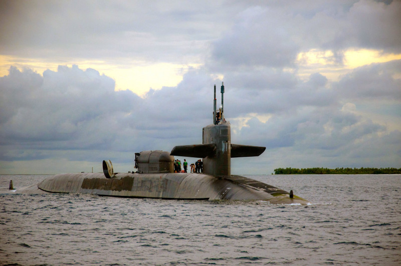 US Navy sailors aboard the guided-missile submarine USS Georgia prepare to dock at the Navy Support Facility Diego Garcia December 12, 2013 in Diego Garcia, British Indian Ocean Territory.