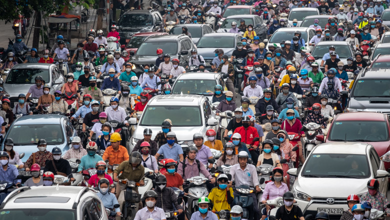 HANOI, VIETNAM - MAY 19: Motorbike riders with face masks are stuck in traffic during the morning peak hour on May 19, 2020 in Hanoi, Vietnam. Though some restrictions remain in place, Vietnam has lifted the ban on certain entertainment facilities and non-essential businesses, including pubs, cinemas and spas &amp; other tourist attractions to recover domestic tourism. On April 23, the Ministry of Transport started to increase domestic flights and trains to major destinations with limited passenger capacity. As of May 19, Vietnam has confirmed 324 cases of coronavirus disease (COVID-19 ) with no deaths in the country, 263 fully recovered and no new case caused by community transmission for 33 days. (Photo by Linh Pham/Getty Images)