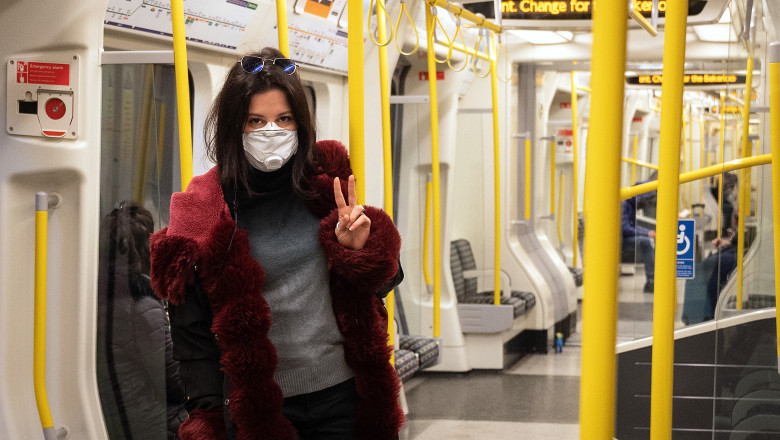 LONDON, ENGLAND - MARCH 20: A woman wears a protective mask as she travels on an underground train on March 20, 2020 in London, England. Mayor of London Sadiq Khan has announced that people must stop all non-essential travel on public transport in the capital due to the ongoing global COVID-19 coronavirus pandemic. (Photo by Leon Neal/Getty Images)