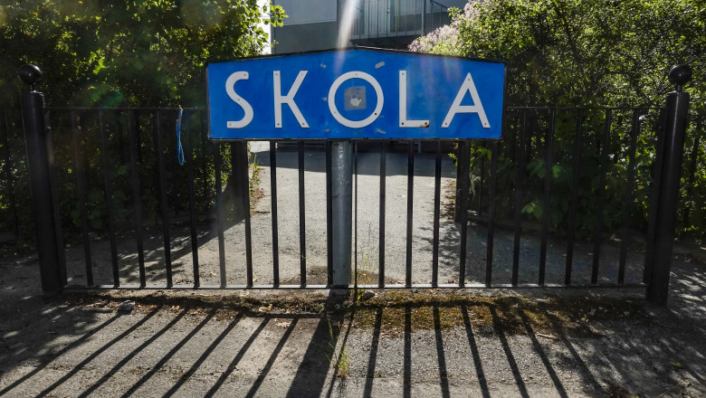 Stockholm, Sweden A sign in Swedish saying "School" and a gate.