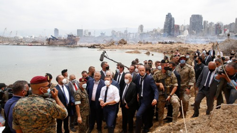 French President Emmanuel Macron (C), flanked by French Foreign Affairs Minister Jean-Yves Le Drian (C,R) visits the devastated site of the explosion at the port of Beirut, on August 6, 2020 two days after a massive explosion devastated the Lebanese capital in a disaster that has sparked grief and fury. French President Emmanuel Macron visited shell-shocked Beirut on August 6, pledging support and urging change after a massive explosion devastated the Lebanese capital in a disaster that left 300,000 people homeless.,Image: 550412039, License: Rights-managed, Restrictions: , Model Release: no