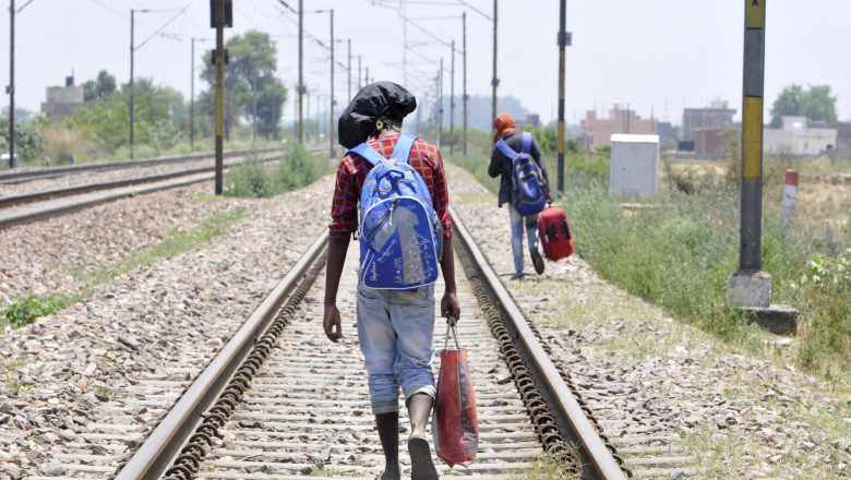 Persoană in India merge pe jos spre casă pe calea ferată