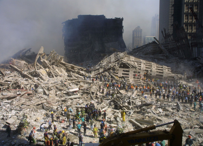 Rescue Workers Search Through WTC Rubble