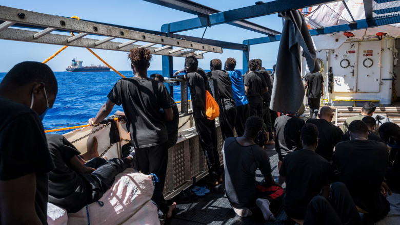 refugiati pe ambarcatiune privesc in larg catre un petrolier