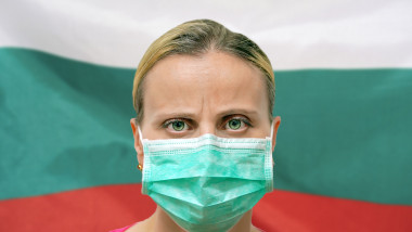 Masked woman face looking at the camera on flag Bulgaria background. The concept of attention to the worldwide spread of the coronavirus worldwide. Coronavirus, virus in Bulgaria.