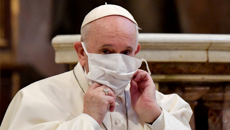 Papa Francisc își aranjează masca în timpul rugăciunii colective pentru pace, unde participă alături de alți lideri religioși, în Biserica Santa Maria din Aracoeli, o biserică veche din Roma