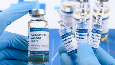 Doze de vaccin ținute în mâini de medici