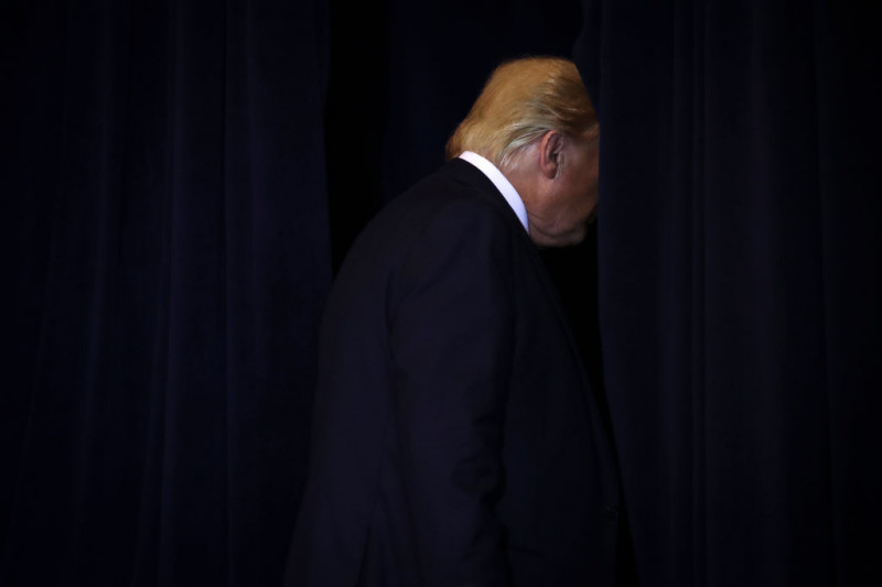 Donald Trump exits the stage, posing from behind