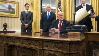 President Donald Trump prepares to sign a confirmation for Defense Secretary James Mattis