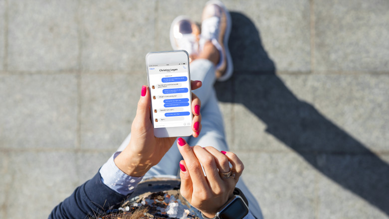 O tânără ține un telefon în mână și folosește Facebook Messenger. Foto: Shutterstock