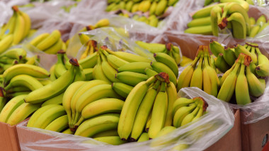 Ripe bananas on boxes in supermarket
