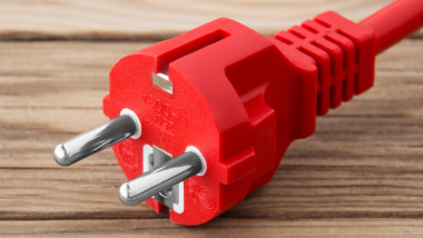 Electricity cable against wooden background