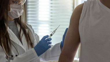 Gloved hands of doctor vaccinating patient against influenza.