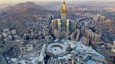 Mecca, imagine aeriana, se vad muntii rosiatici, marea moschee cu piatra neagra in mijlocul locului de pelerinaj, turnul mecca, toate pustii