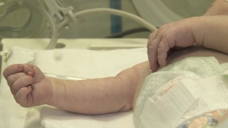 Mâna unui bebeluș aflat în incubator.