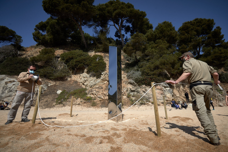 A metallic monolith appears on a beach in Catalonia