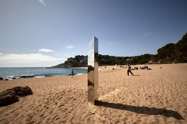 A metallic monolith appears on a beach in Catalonia