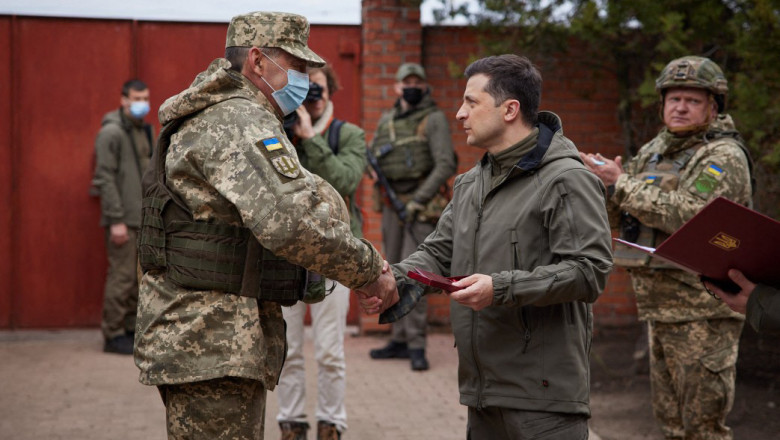 Volodimir Zelenski dă mâna cu un soldat ucrainean.