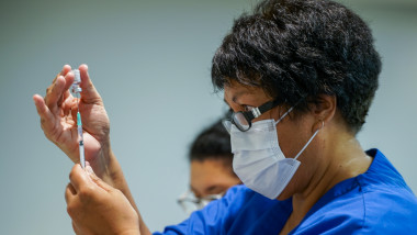 un medic pregăteste seringa cu vaccin