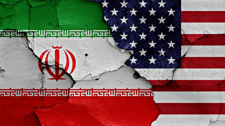 flags of Iran and USA painted on cracked wall