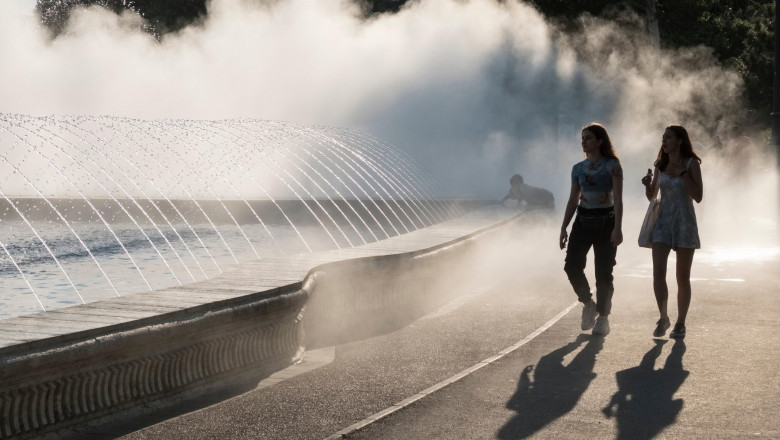 Unirii Square, Bucharest, Romania. As part of the spectacular fountains, a water misting system cools passers-by during the sweltering summer heat