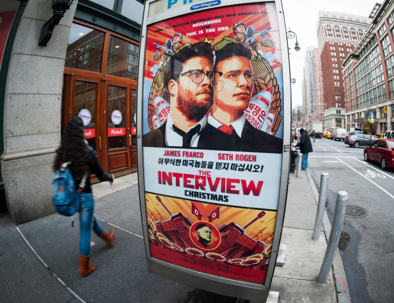 New York, New York, USA. 17th Dec, 2014. Pedestrians walk past an advertisement for "The Interview", a comedic film about North Korean leader Kim Jong-un's assassination, in New York on Wednesday, December 17, 2014. The planned premiere at the Landmark Su