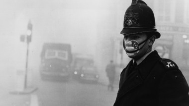 polițist britanic poartă o mască în anii 50 pentru a se proteja de smog.