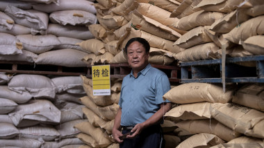 Chinese pig farmer and billionaire Sun Dawu posing at a feed warehouse in Hebei