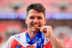 Lachlan Coote (1) of St Helens bites his Challenge cup winners medal