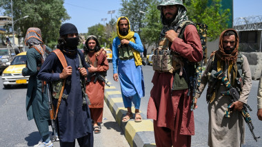 Taliban fighters stand guard along a street near the Zanbaq Square in Kabul on August 16, 2021