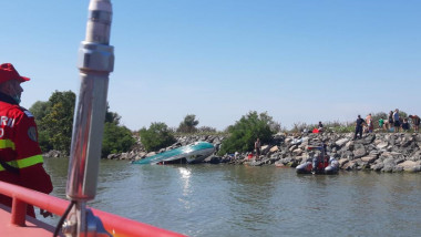 Barcă răsturnată pe malul canalului Sulina.