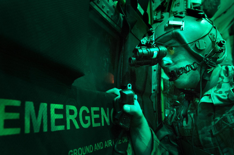 Senior Airman Larry Webster scans for potential threats using night vision goggles after completing a cargo airdrop Oct. 7, 2013, in Ghazni Province, Afghanistan. Webster is a 774th Expeditionary Airlift Squadron loadmaster. Master Sgt. Ben Bloker)