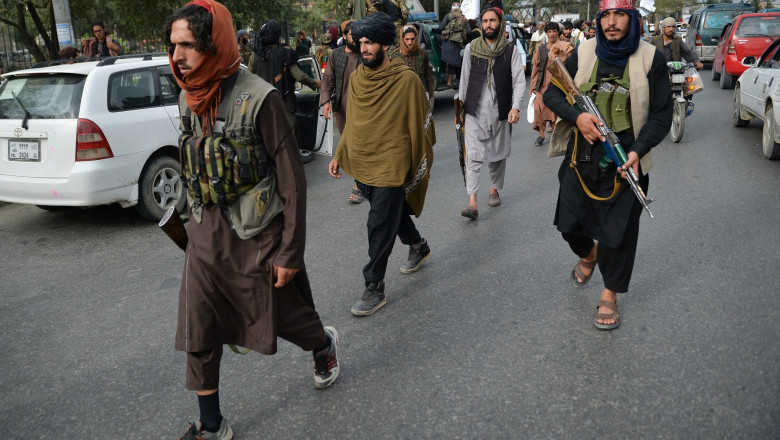 Taliban fighters gather along a street during a rally in Kabul on August 31, 2021 as they celebrate after the US pulled all its troops out of the country to end a brutal 20-year war -- one that started and ended with the hardline Islamist in power
