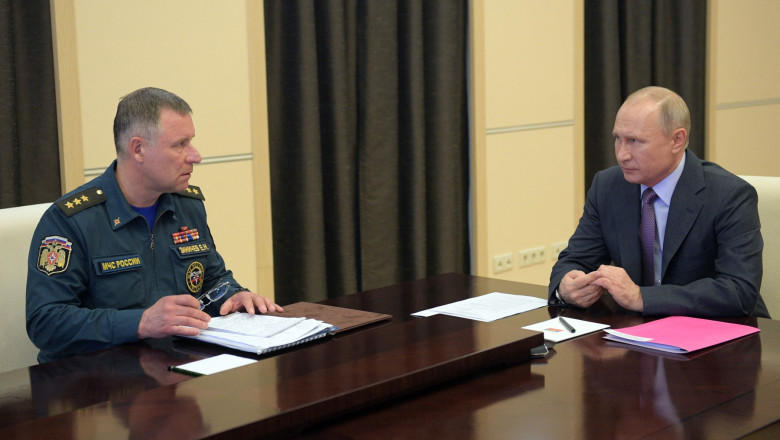 Russian President Vladimir Putin and Emergencies Minister Yevgeny Zinichev attend a meeting on the situation in regions hit by floods and wildfires via a teleconference call at the Novo-Ogaryovo state residence outside Moscow on April 27, 2020