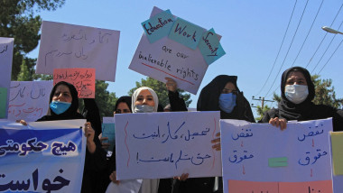 Afghan women hold placards as they take part in a protest in Herat on September 2, 2021. Defiant Afghan women held a rare protest on September 2 saying they were willing to accept the all-encompassing burqa if their daughters could still go to school under Taliban rule.