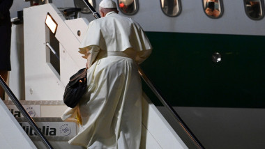 Papa Francis urcă scările pentru a se îmbarca într-un avion