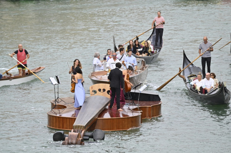 Parade in Venice on the Grand Canal of the Violin of Noah, the floating sculpture by Livio De Marchi, with craftsmen and a quartet of musicians on board