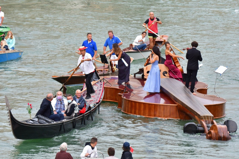 Parade in Venice on the Grand Canal of the Violin of Noah, the floating sculpture by Livio De Marchi, with craftsmen and a quartet of musicians on board