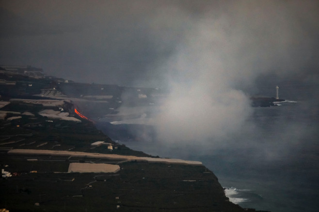 Lava reaching the sea in La Palma creates a low island more than half a kilometre wide